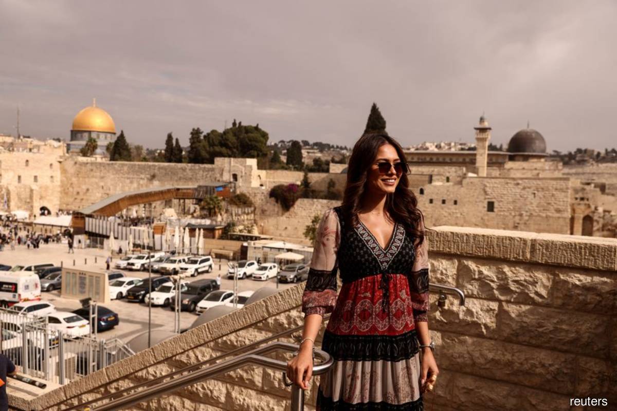 The reigning Miss Universe, Andrea Meza of Mexico, poses for a photo on Nov 17, 2021, in front of the Western Wall — Judaism's holiest prayer site, and the Dome of the Rock, located on the compound known to Muslims as the Noble Sanctuary and to Jews as Temple Mount in Jerusalem's Old City, as part of the preparation for Israel hosting Miss Universe 2021 later this year (Photo by Ronen Zvulun/Reuters filepix)